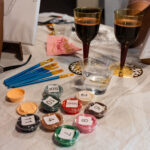 Paint, brushes, and wine.